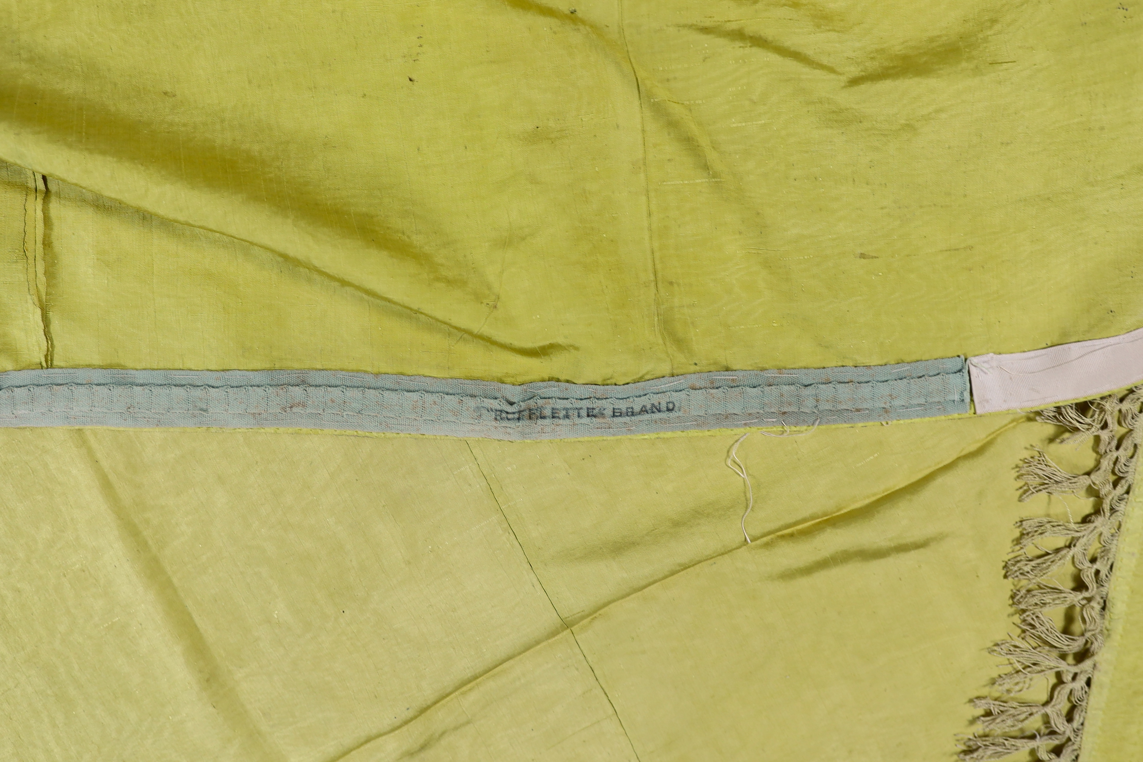 A large Regency yellow silk curtain, with fringed base, French short loom ribbed silk panels made into a wide curtain, with fringing on each side and at the bottom, 9ft wide x 8ft 6in. long